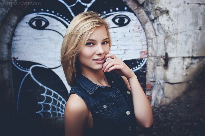 Kristina Nevskaya posing in front of graffiti