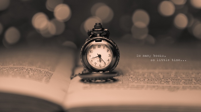 Pocket watch on an open book with quote