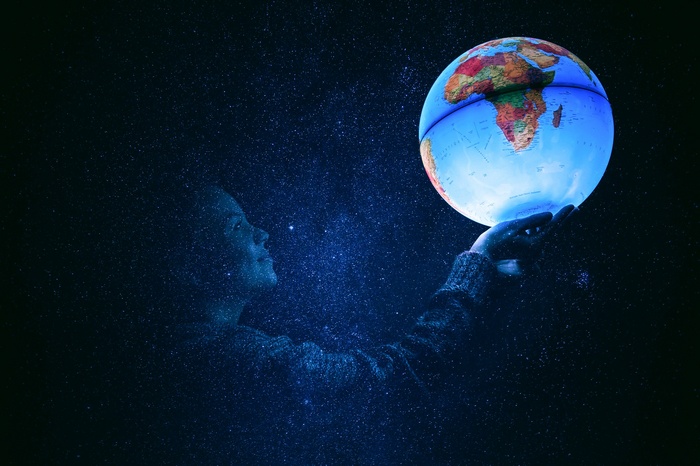 Woman holding a glowing globe in a starry night