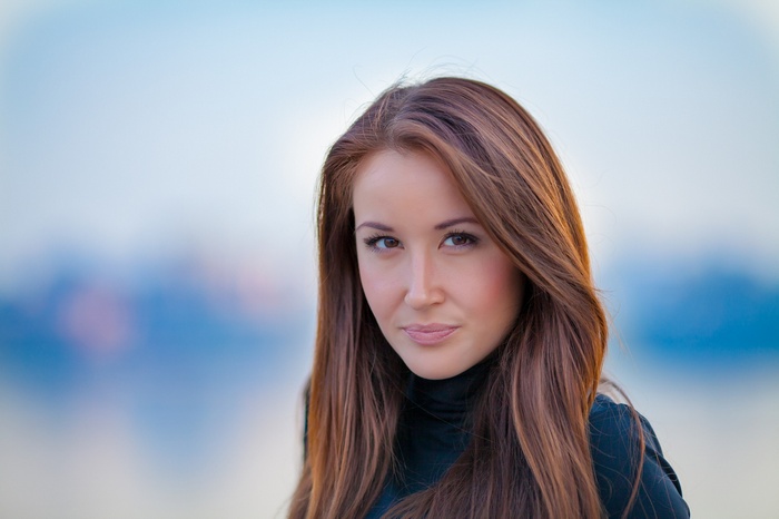 Portrait of a young woman with long brown hair