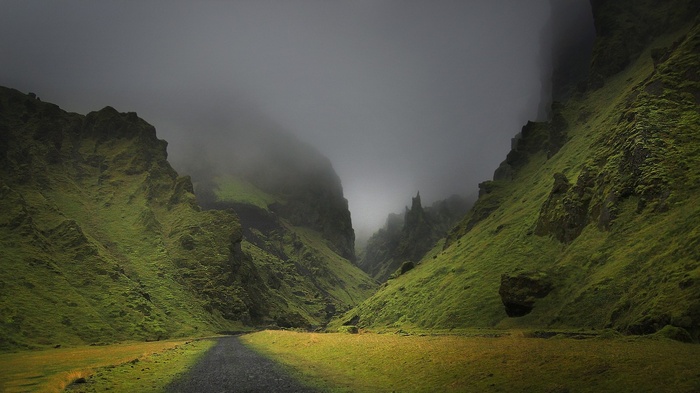 Misty mountain valley with a dirt road