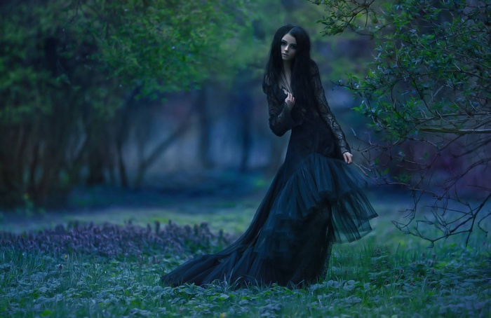 Woman in black dress in a forest