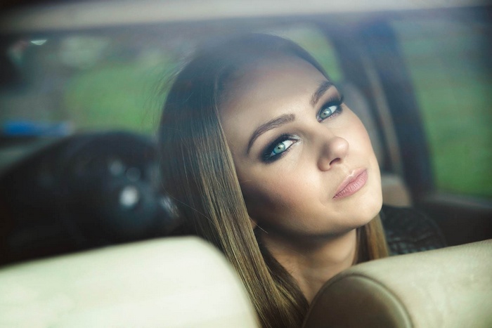Woman with blue eyes in a car