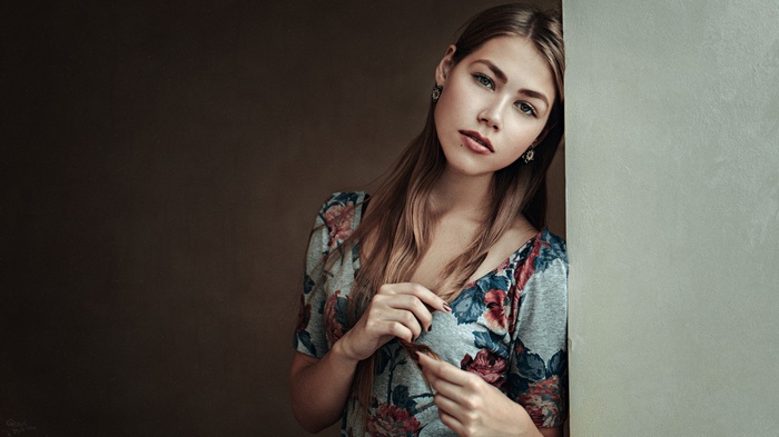 Woman with auburn hair and floral dress by Georgy Chernyadyev