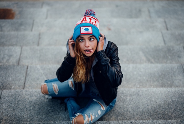 Woman wearing a California Republic beanie on stairs