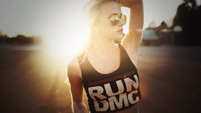 Woman wearing RUN DMC tank top and sunglasses