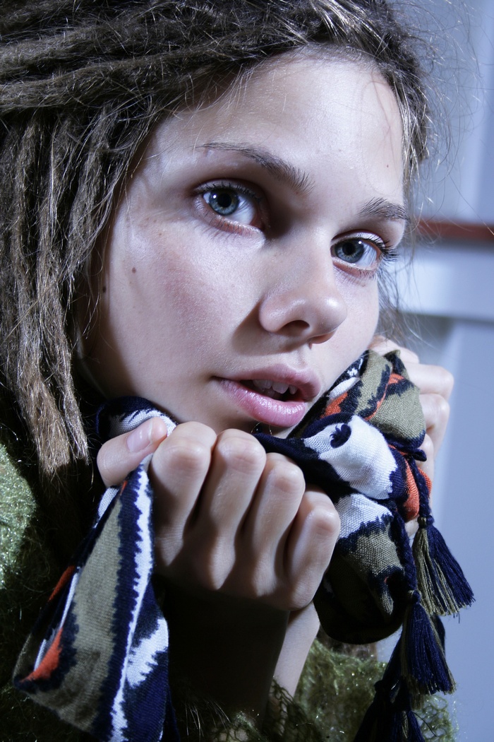 Young woman with dreadlocks holding a scarf