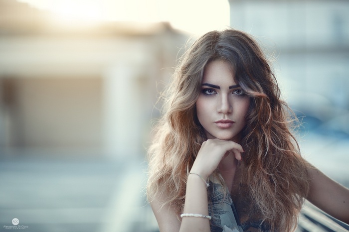 Portrait of a young woman with wavy brown hair by Alessandro Di Cicco