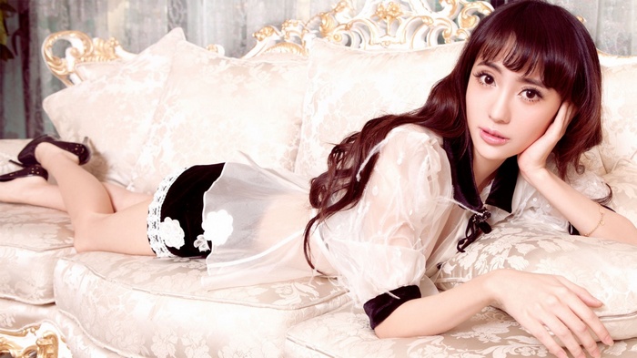 Asian woman lying on a couch