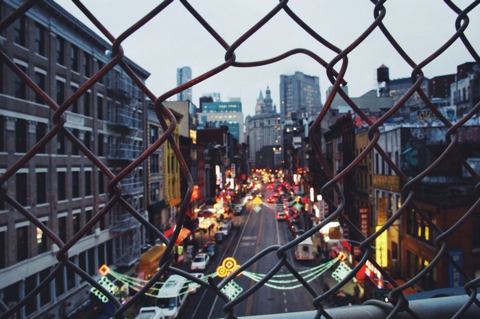 New York City street viewed through a chain-link fence