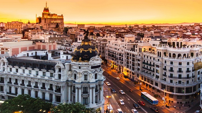 Madrid cityscape at sunset with historic buildings and traffic