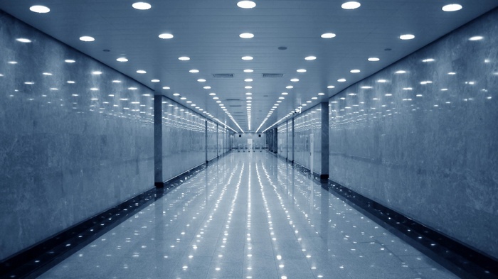 Modern marble hallway with ceiling lights and reflections