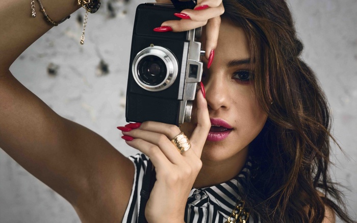 Selena Gomez holding a vintage camera