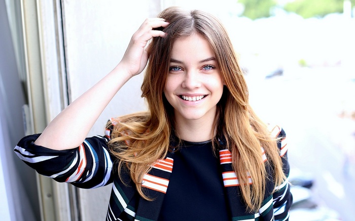 Barbara Palvin smiling with hand in hair