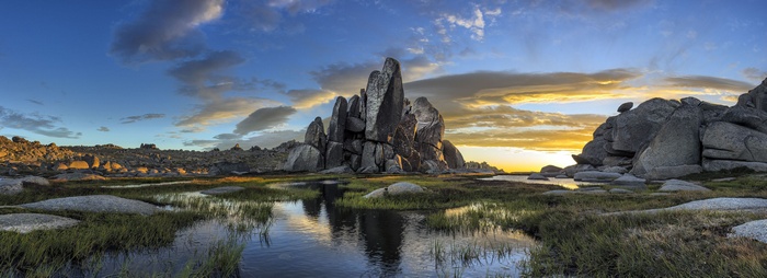 Rock formations in Australia at sunrise with clouds and water