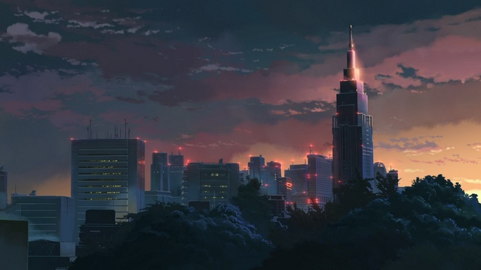Cityscape at sunset with skyscrapers and clouds