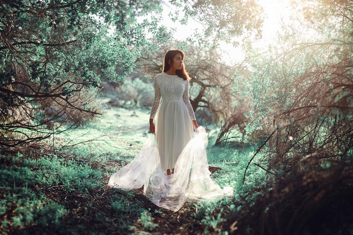 Woman in white dress in a forest