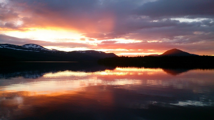Sunset over a lake with mountains in Sweden