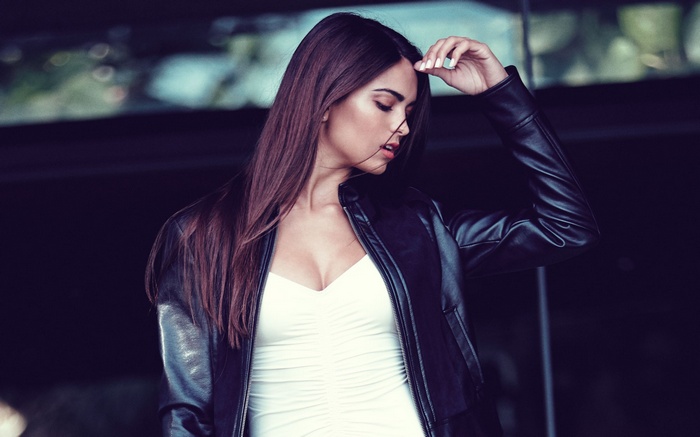 Kyra Santoro in a black leather jacket and white top