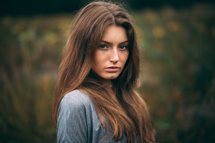 Woman with freckles and long brown hair