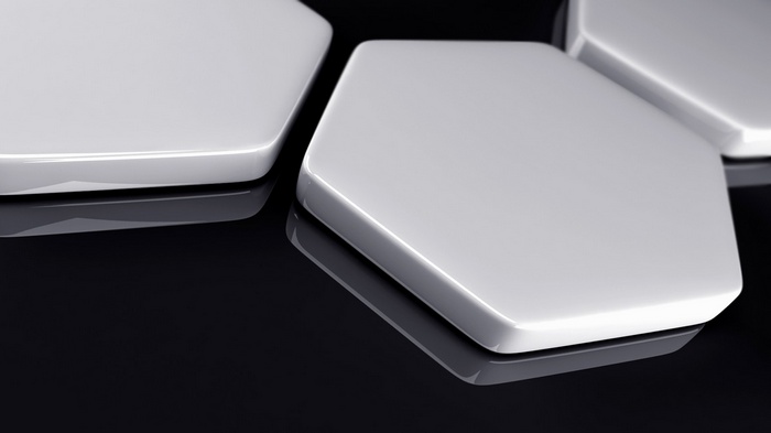 White hexagons on a black reflective surface