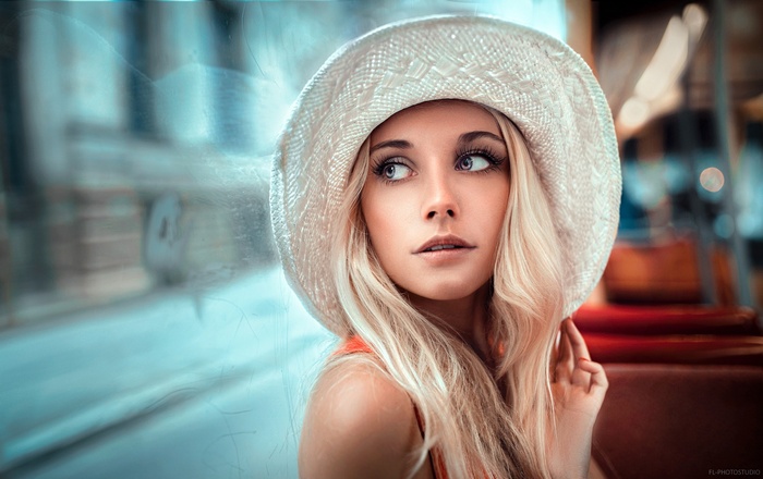 Woman with blonde hair wearing a white hat
