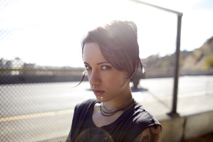 Woman with nose piercing and tattoos