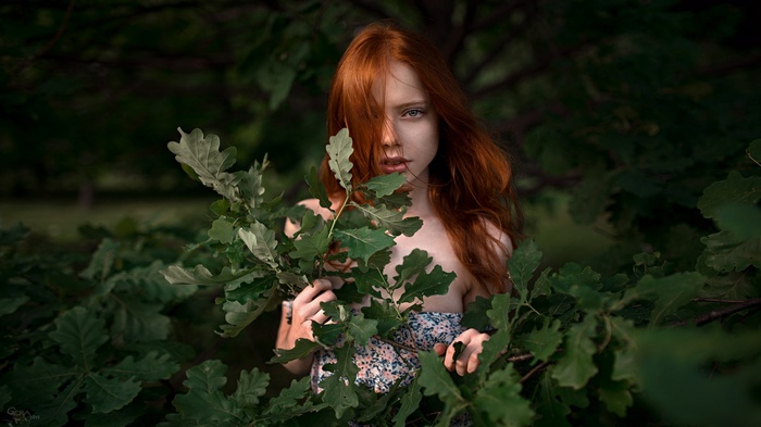 Redhead woman among oak trees