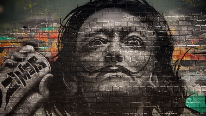 Graffiti portrait of Salvador Dalí on a brick wall