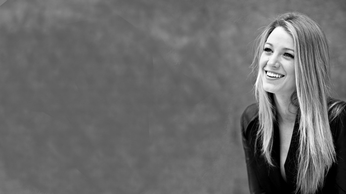 Blake Lively smiling in a black top