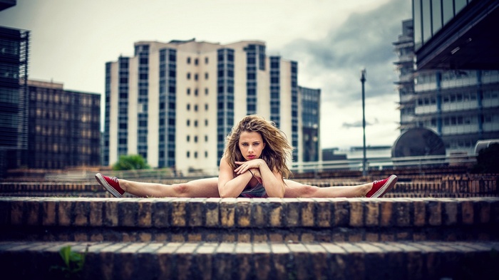 Woman performing a split on brick steps
