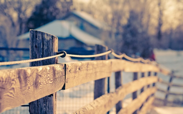 Wooden fence in winter with depth of field