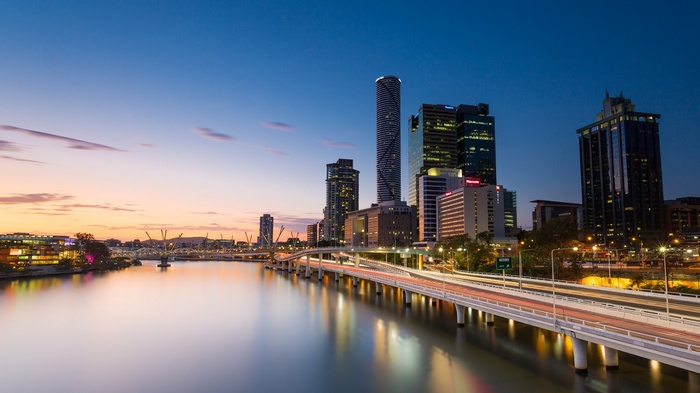 Brisbane cityscape with river and bridge at sunset