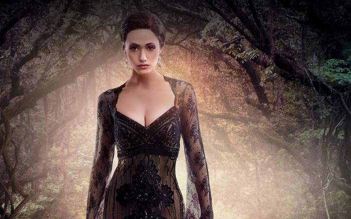 Emmy Rossum in a black lace dress in a forest