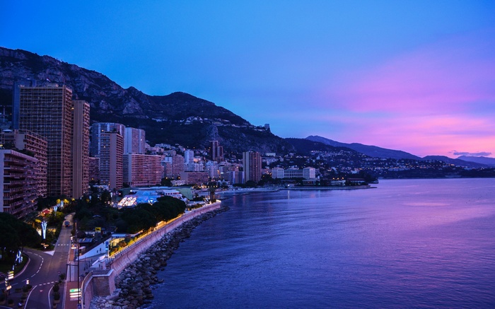 Cityscape and sea at dusk with mountains