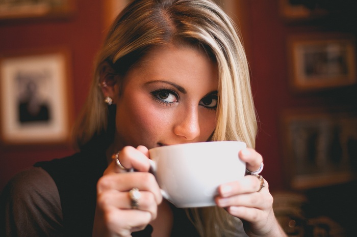 Woman drinking from a white mug
