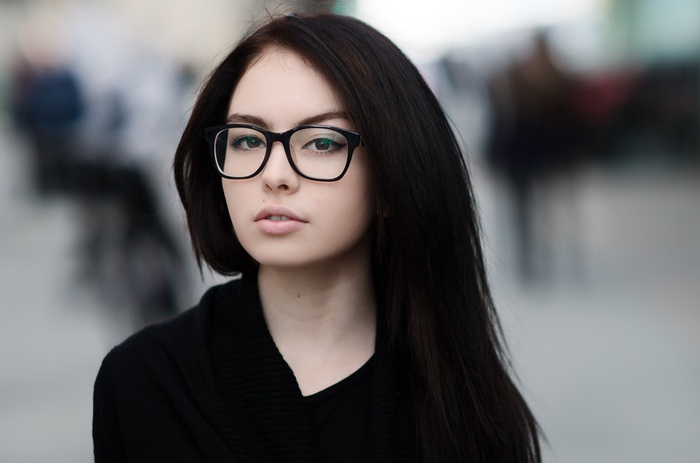 Woman with glasses wearing a black sweater