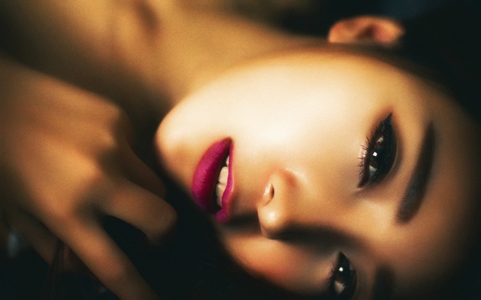 Close-up of an Asian woman's face with vibrant lipstick