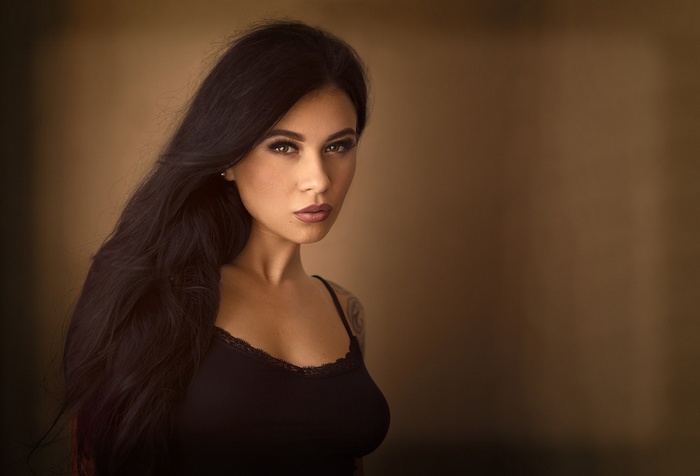 Brunette woman with black hair and green eyes