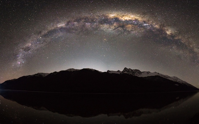 Milky Way over mountains and reflection