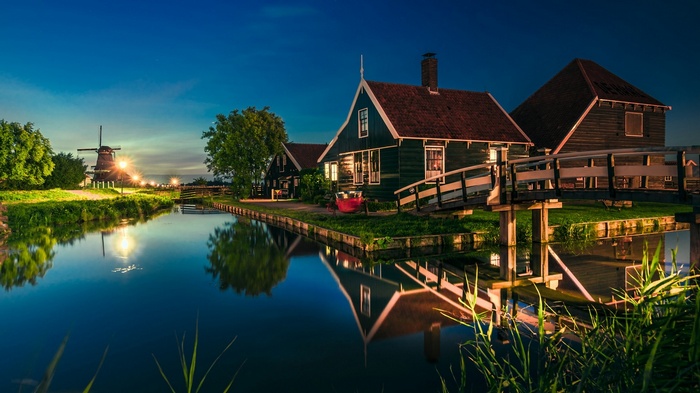 Zaanse Schans Netherlands at dusk with canal and windmill