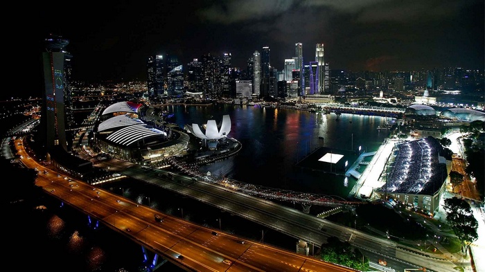 Singapore cityscape at night with Marina Bay Sands and highway