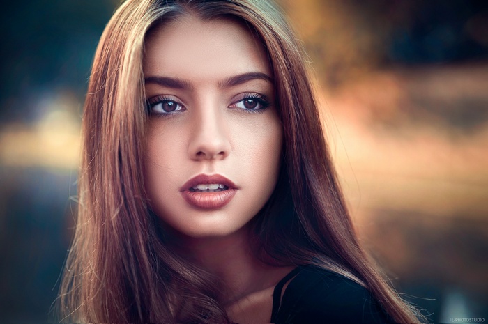 Portrait of a young woman with long brown hair
