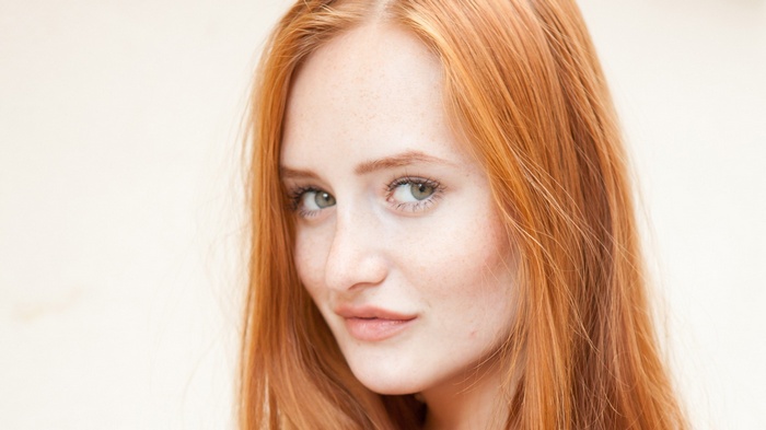 Redhead woman with freckles and green eyes