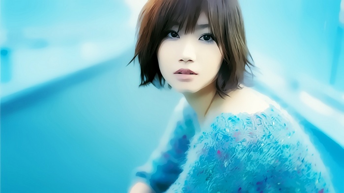 Asian woman with brown eyes in a blue dress