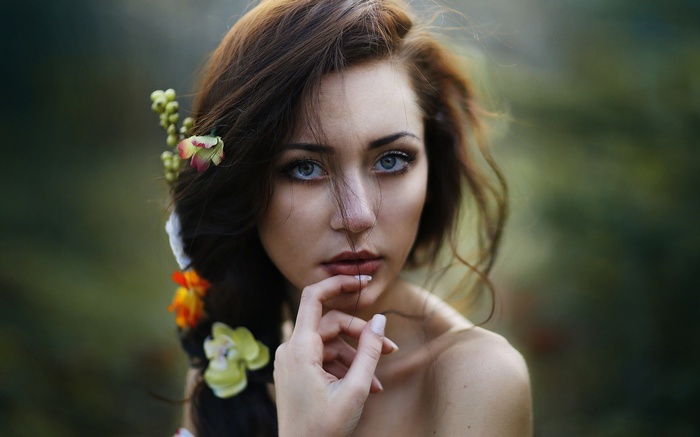 Woman with flowers in her hair and blue eyes