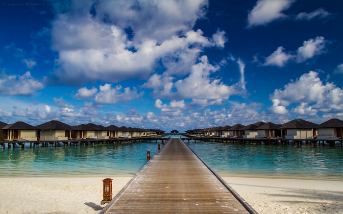 Wooden walkway to overwater bungalows in the Maldives