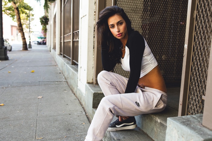 Anna Monique sitting on steps in casual wear