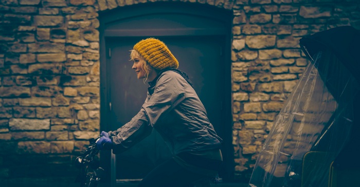 Woman in yellow hat riding a bicycle
