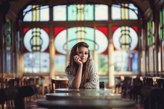 Woman in cafe with stained glass windows